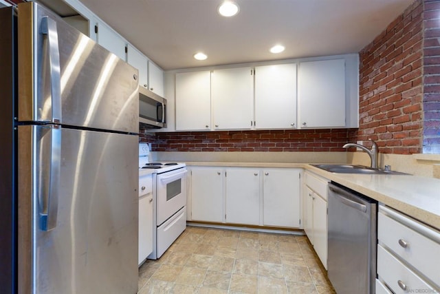 kitchen with white cabinets, stainless steel appliances, and sink