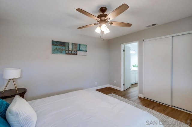 bedroom featuring ceiling fan, a closet, and hardwood / wood-style floors