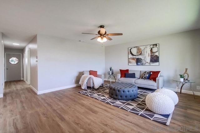 living room featuring ceiling fan and hardwood / wood-style floors