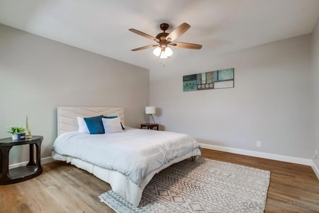 bedroom with wood-type flooring and ceiling fan