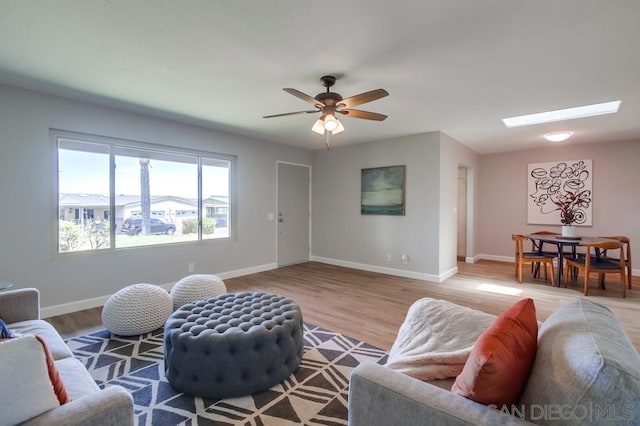 living room featuring light hardwood / wood-style flooring and ceiling fan