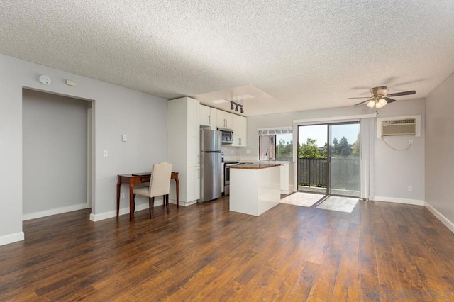 kitchen featuring dark hardwood / wood-style flooring, stainless steel appliances, ceiling fan, sink, and white cabinetry