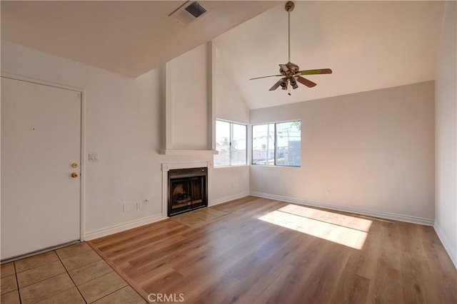 unfurnished living room featuring high vaulted ceiling, light wood-type flooring, and ceiling fan