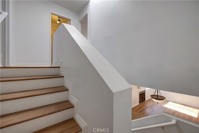 stairway featuring wood-type flooring