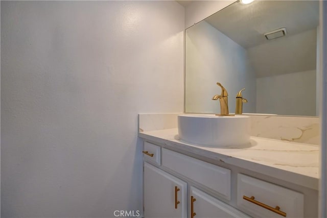 bathroom with vanity and vaulted ceiling