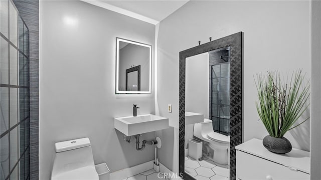 bathroom with a shower, sink, tile patterned flooring, and toilet