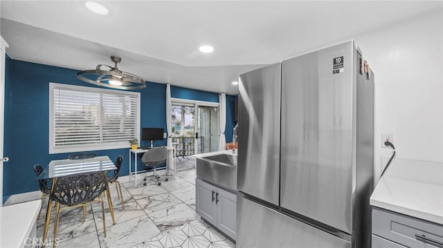 kitchen featuring a healthy amount of sunlight, stainless steel refrigerator, ceiling fan, and gray cabinetry