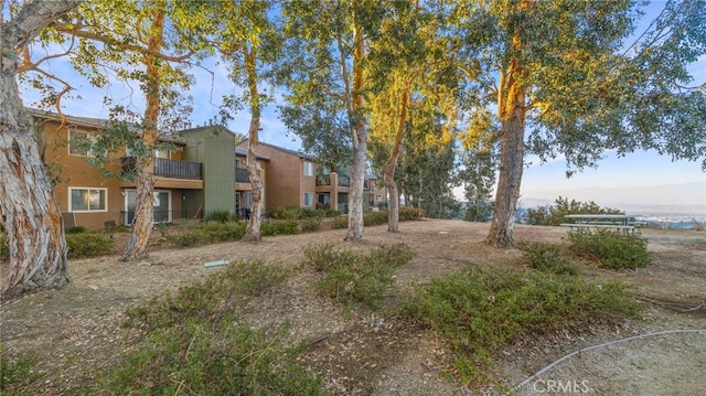 view of yard featuring a balcony