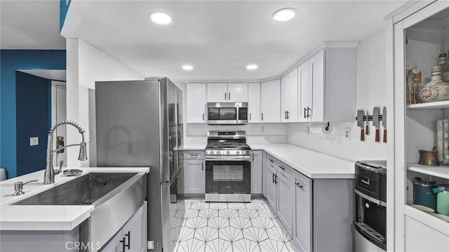 kitchen featuring white cabinetry, sink, and appliances with stainless steel finishes