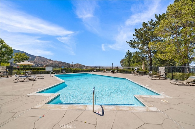 view of pool featuring a mountain view and a patio