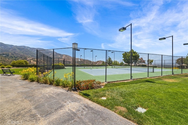 view of sport court with a lawn and a mountain view