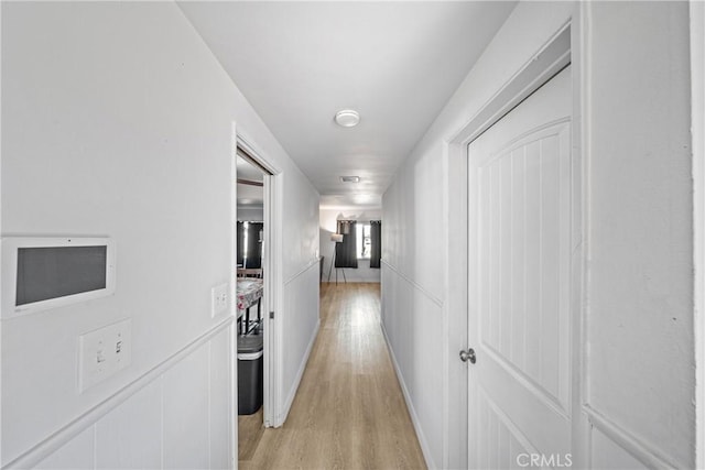 hallway with light hardwood / wood-style flooring