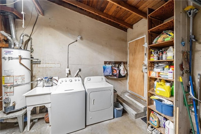 washroom with washer and dryer and strapped water heater