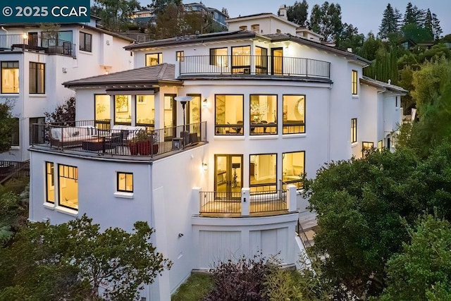 rear view of property with a balcony