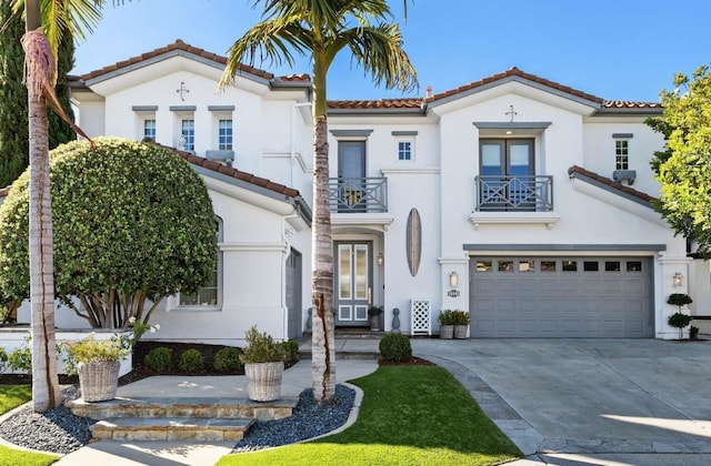 mediterranean / spanish-style house with a garage and a balcony