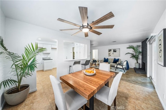 dining area featuring ceiling fan and light tile patterned flooring