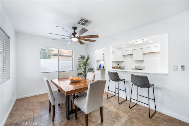 dining area with ceiling fan and light tile patterned flooring