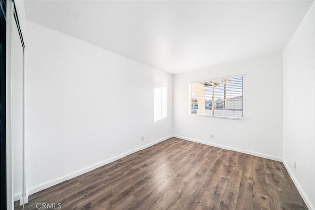 spare room with dark wood-type flooring