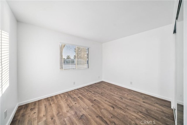 empty room with hardwood / wood-style flooring