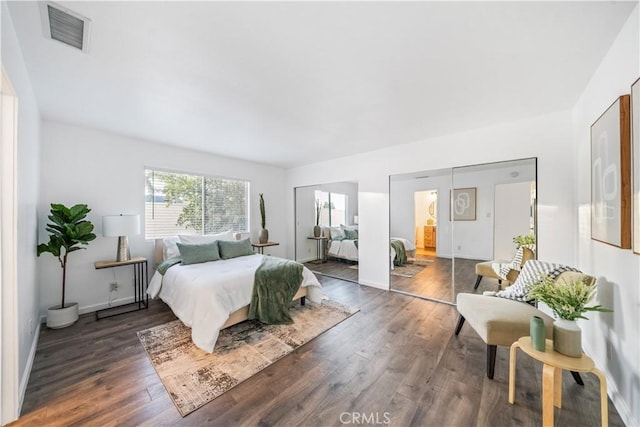 bedroom with dark wood-type flooring