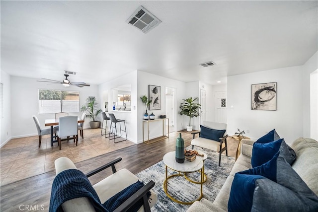 living room with ceiling fan and hardwood / wood-style flooring