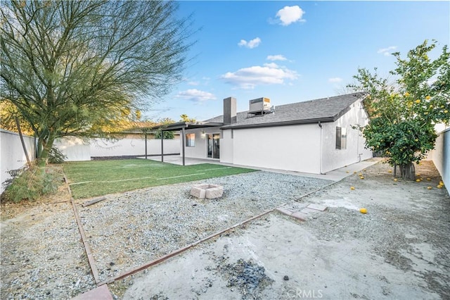 rear view of property with a yard and a patio