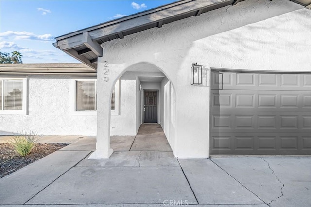 doorway to property with a garage