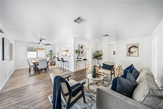 living room with hardwood / wood-style floors and ceiling fan