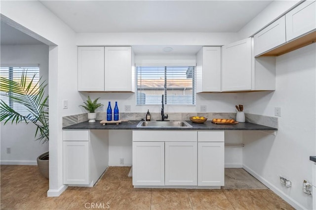 kitchen with white cabinetry and sink