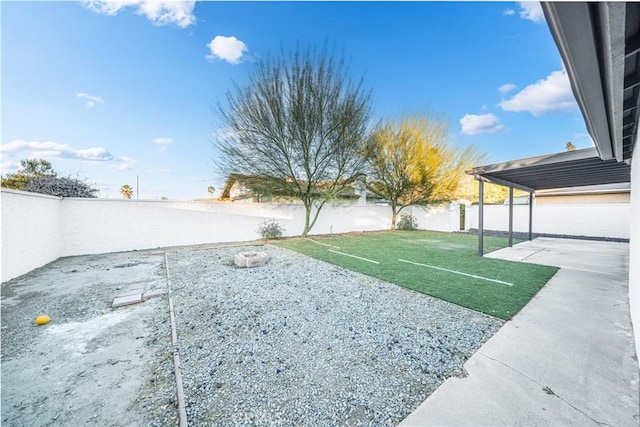 view of yard with a patio area and a water view