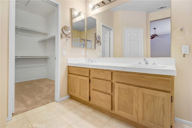 bathroom with tile patterned floors, ceiling fan, and vanity