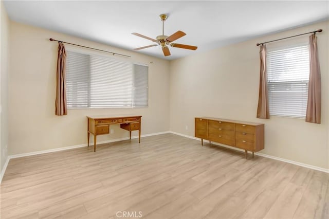 empty room featuring ceiling fan and light hardwood / wood-style floors