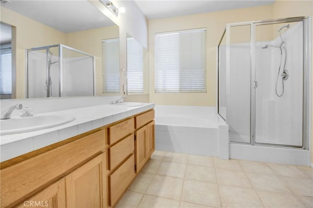 bathroom with tile patterned floors, vanity, and separate shower and tub