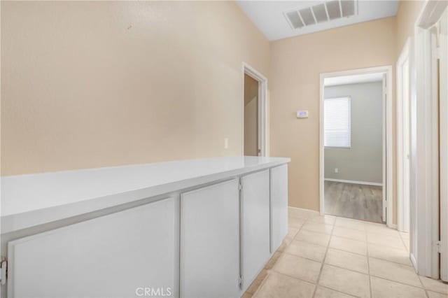 hallway featuring light tile patterned floors