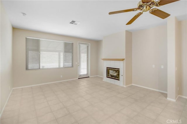 unfurnished living room featuring ceiling fan and a fireplace