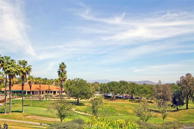 view of home's community featuring a lawn and a mountain view