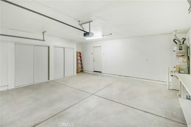 garage with strapped water heater and a garage door opener