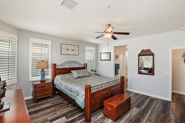 bedroom featuring ceiling fan, dark hardwood / wood-style floors, and multiple windows