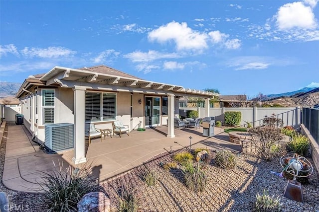 back of house with a mountain view, a patio, and central air condition unit