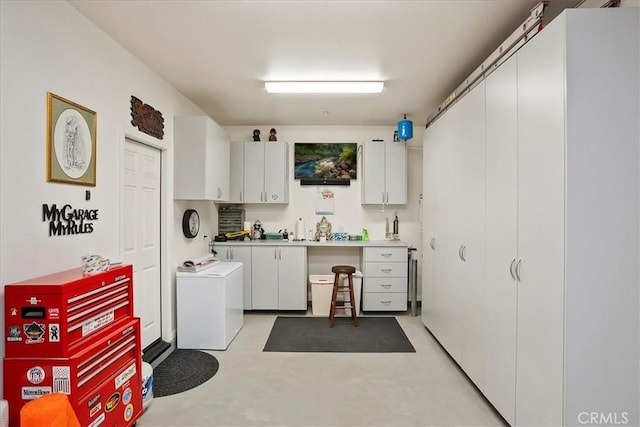 laundry room with washer and dryer and cabinets