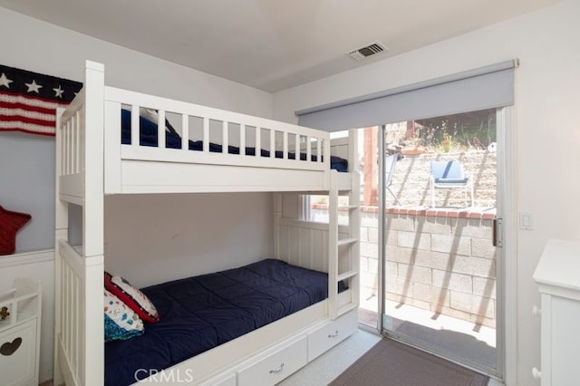 bedroom with access to exterior and visible vents