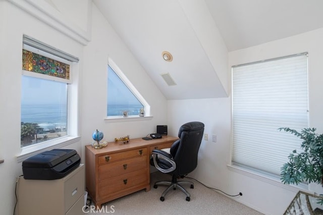 office area with light colored carpet and vaulted ceiling