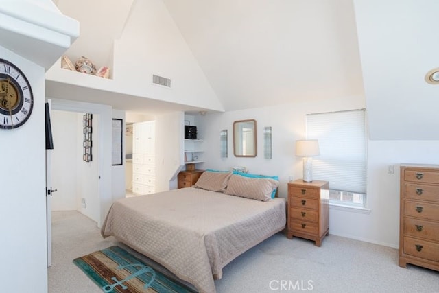 bedroom featuring light colored carpet and high vaulted ceiling