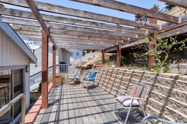 wooden deck featuring a pergola