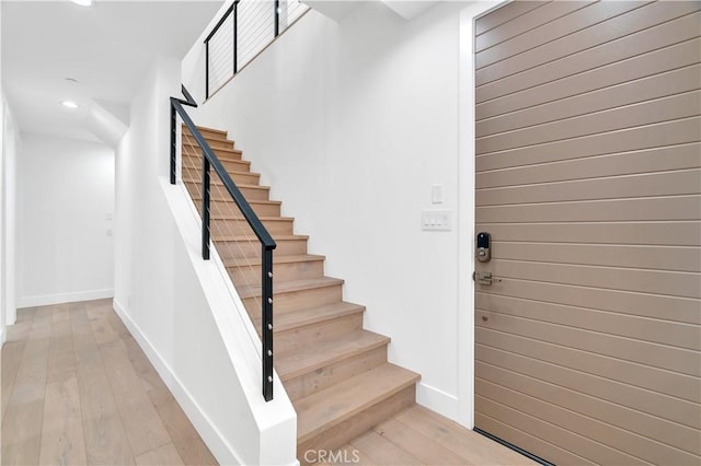 staircase featuring hardwood / wood-style floors