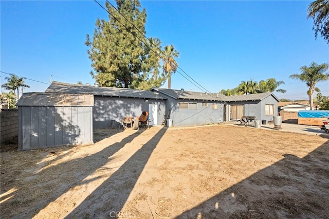 rear view of property with a shed