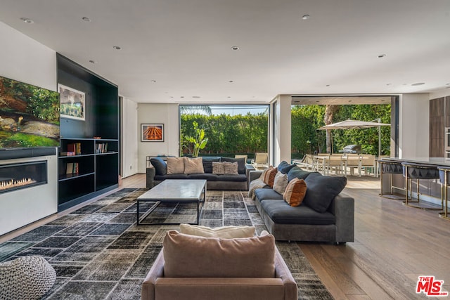 living room with expansive windows and wood-type flooring