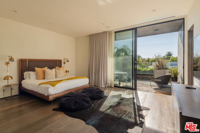 bedroom with expansive windows, wood-type flooring, access to outside, and multiple windows