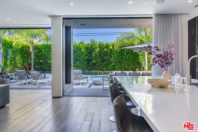 entryway with expansive windows and light hardwood / wood-style flooring