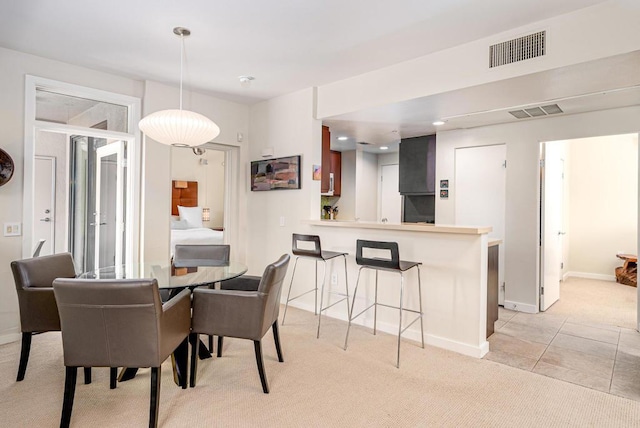 dining room featuring light carpet